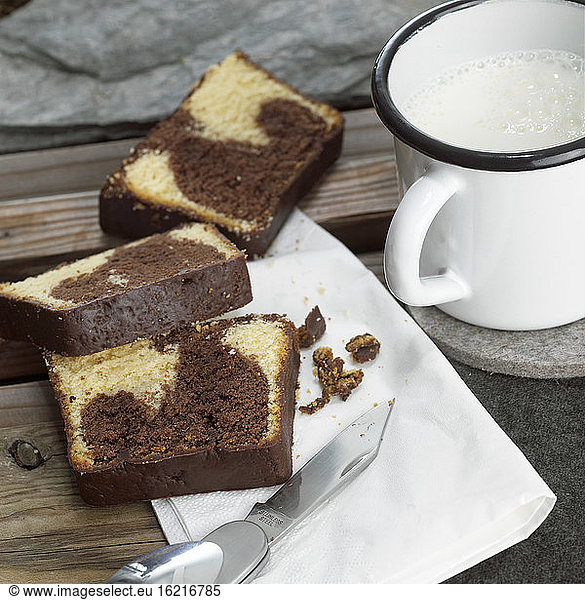 Slices of marble cake with mug of milk