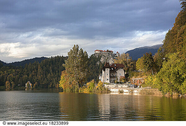 Slovenia  Bled  Old villa on shore of Lake Bled with Bled Castle in distant background