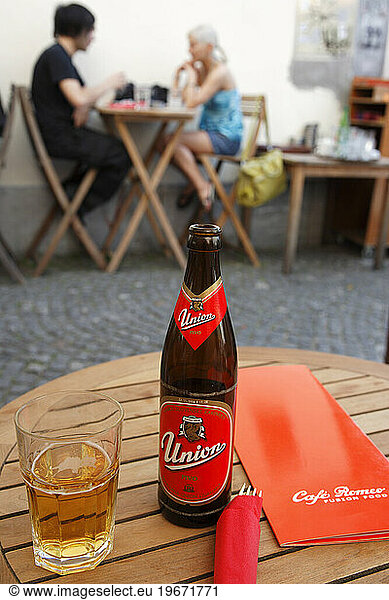 Slovenia. Ljubljana Old Town. Stari Trg. A bottle and glass of the locally brewed Union Beer. Cafe Romeo.