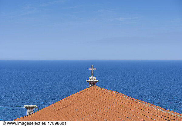 Slovenia  Piran  Cross on rooftop of Saint George Church with Adriatic Sea in background