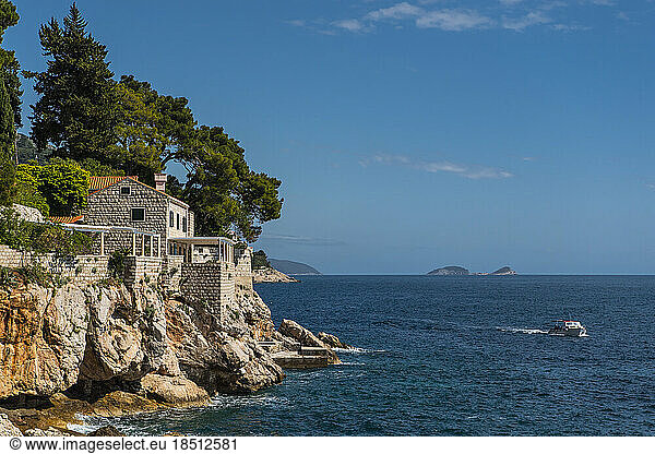 small boat passing the coastline at the Dalmatian sea