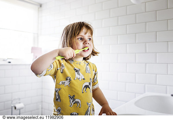 Small girl (2-3) brushing teeth