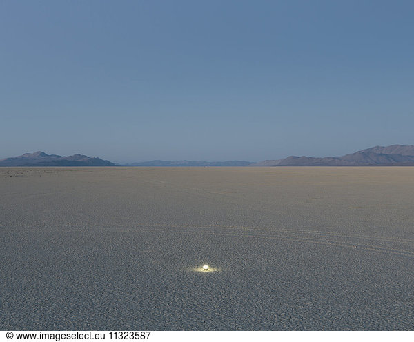 Small glowing light on vast playa  Black Rock Desert  Nevada