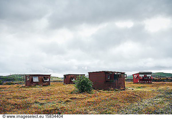 Small houses on deserted field at countryside