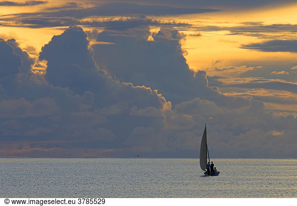 Small sailing boat in front of thunderclouds  Maldives