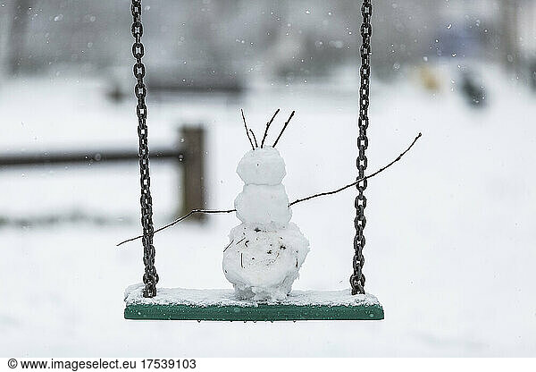 Small snowman on chain swing
