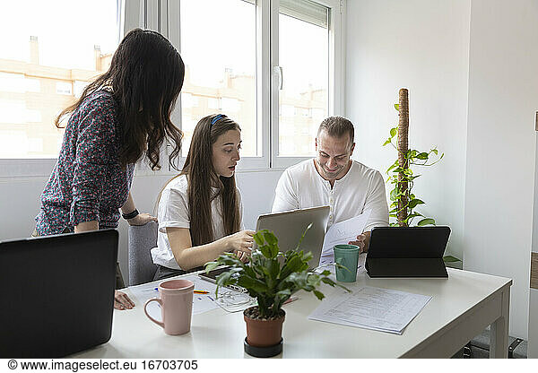 Small startup colleagues working in modern office together
