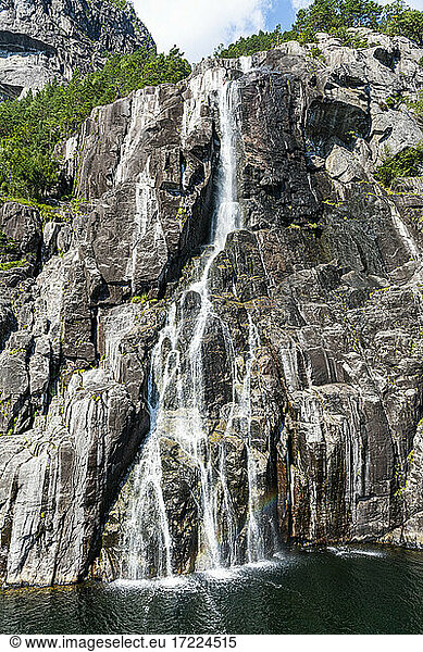 Small waterfall splashing down steep cliff in Lysefjord