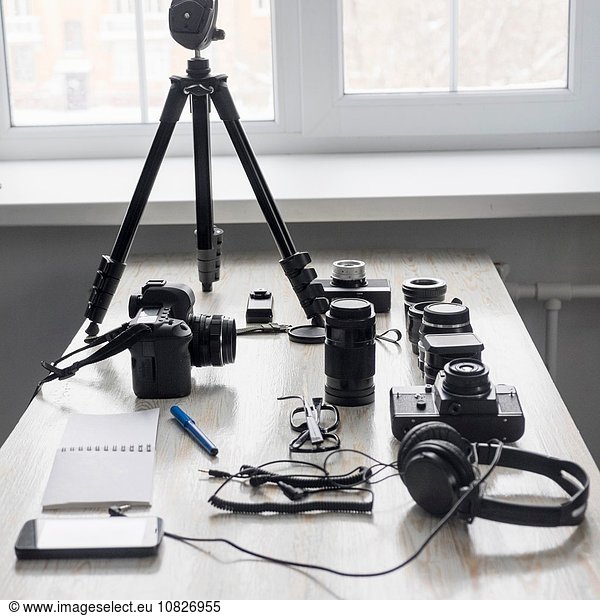 Smartphone and photography equipment on studio desk