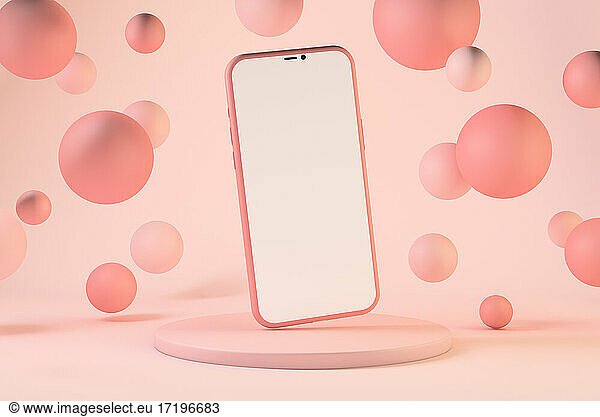 Smartphone with pastel pink floating spheres