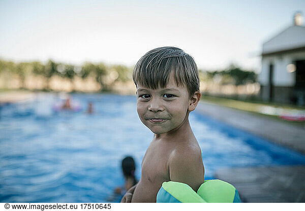 Smiling boy against swimming pool