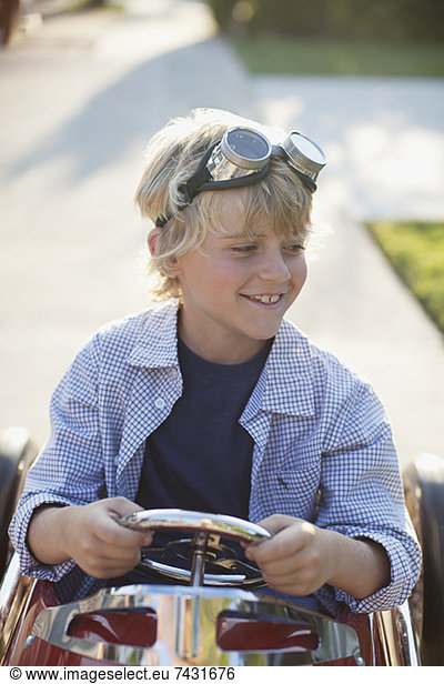 Smiling boy playing in go cart