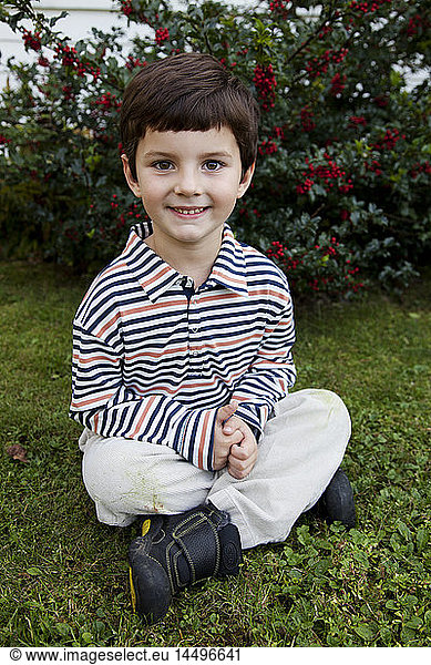 Smiling Boy Sitting on Ground  Portrait