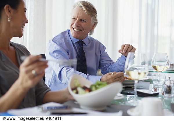 Smiling business people having lunch in restaurant