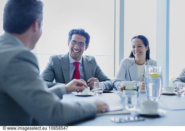 Smiling business people talking in conference room