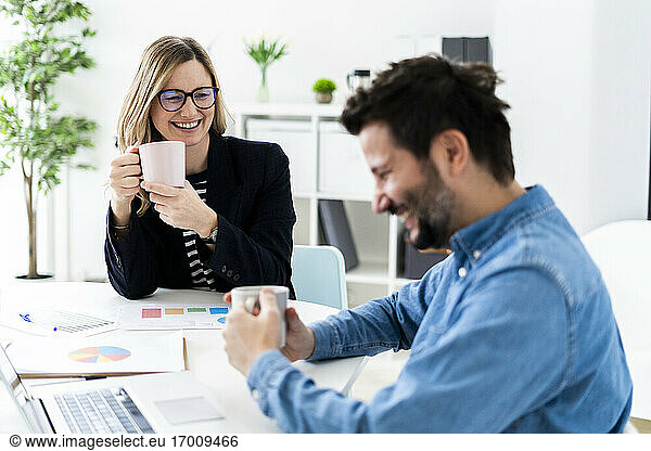 Smiling business people talking in office