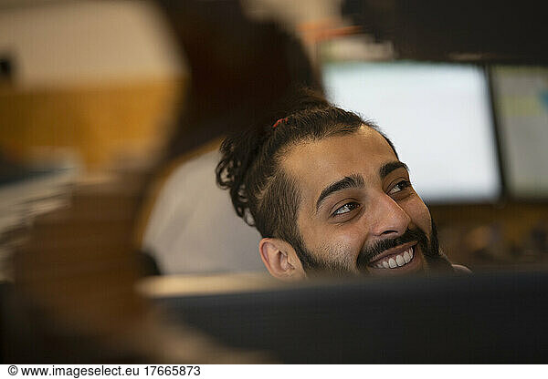 Smiling businessman looking away in office