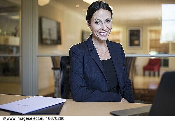 Smiling Businesswoman in Office with computer