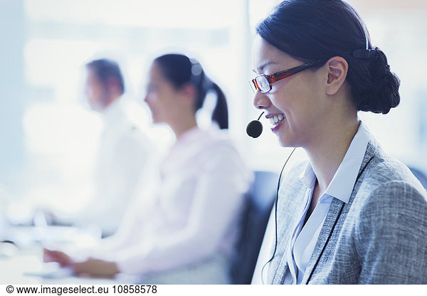 Smiling businesswoman talking on the phone with headset