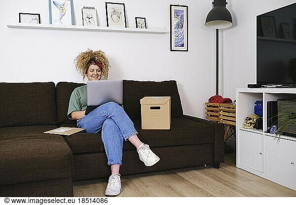 Smiling businesswoman working on laptop at home
