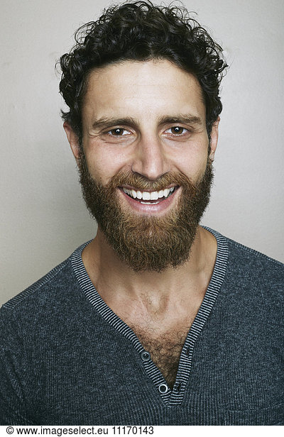 Smiling Caucasian man with beard looking at camera