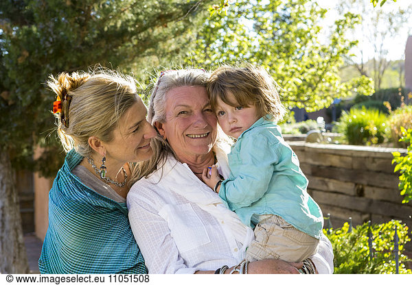 Smiling Caucasian multi-generation family posing outdoors