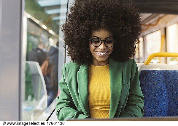 Smiling commuter traveling in tram for work