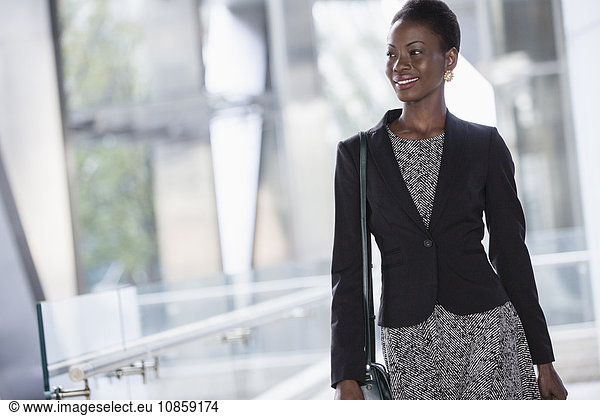 Smiling corporate businesswoman looking away