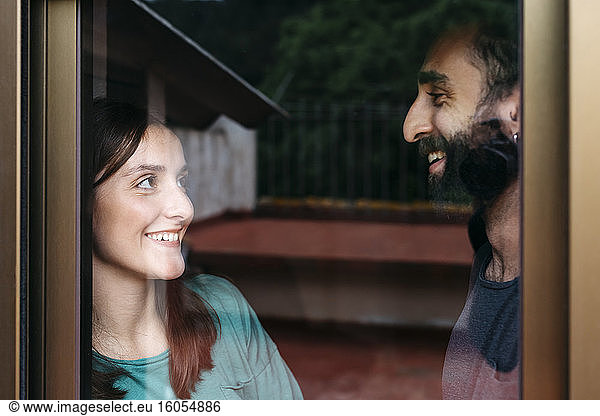Smiling couple at window