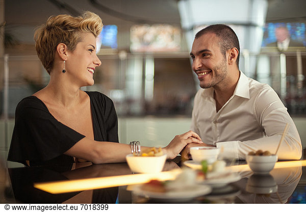 Smiling couple relaxing at bar