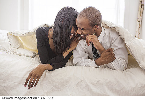 Smiling couple relaxing on bed