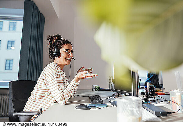 Smiling customer service representative working at desk in office