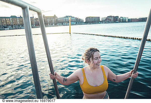 Smiling Danish Woman On Ladder Into Cold Water Copenhagen Denmark