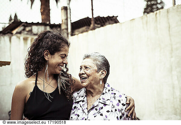 Smiling embrace in a bright summer day of Mexican women in family