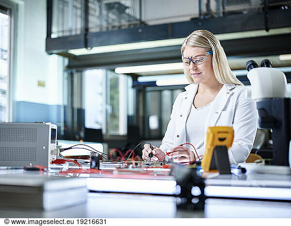 Smiling engineer working in laboratory