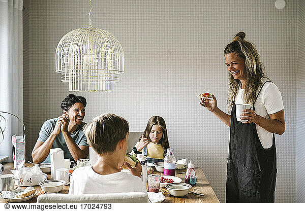 Smiling family having breakfast at dining table