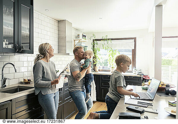 Smiling family in kitchen at home