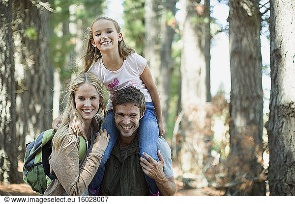 Smiling family in woods
