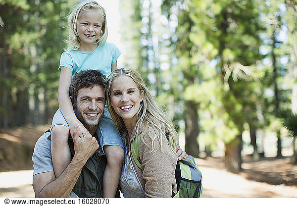 Smiling family in woods