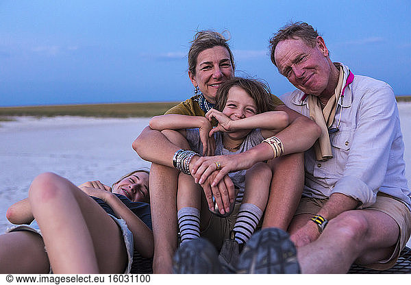 smiling family on top of safari vehicle  Nxai Pan  Botswana