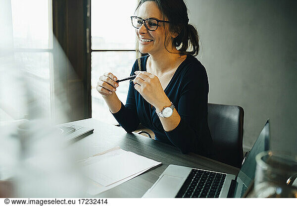Smiling female entrepreneur in board room at office