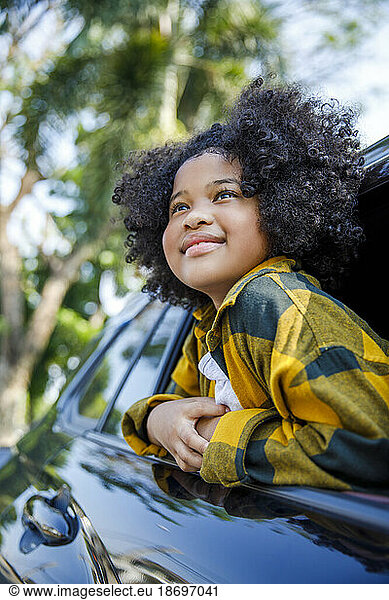 Smiling girl contemplating in car
