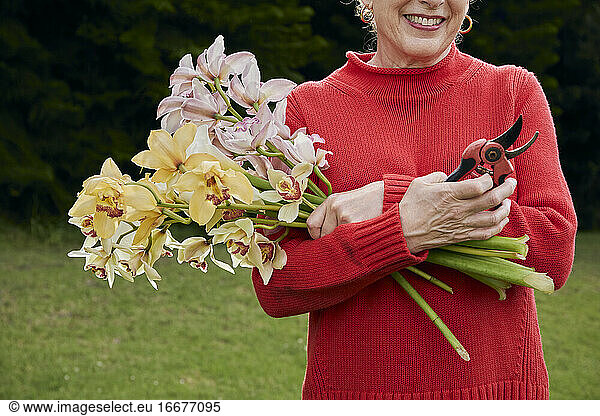 Smiling Grandma Holding Fresh Cut Flowers from the Garden