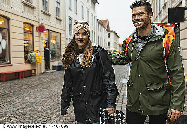 Smiling heterosexual couple exploring city