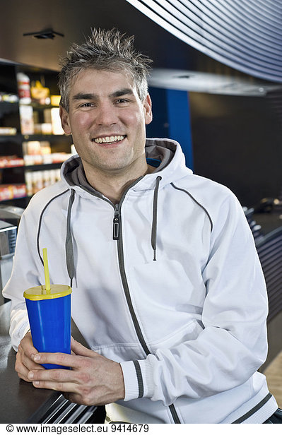 Smiling man at the bar of a gym