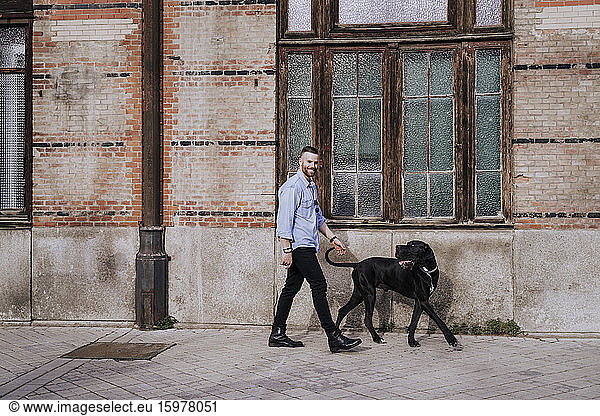 Smiling man going walkies with his dog