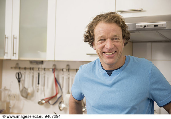 Smiling man in kitchen