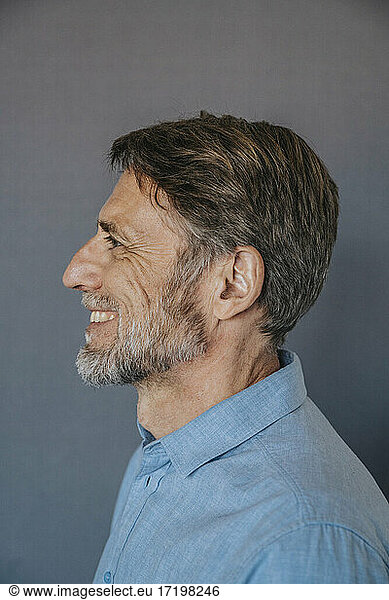 Smiling man over gray background