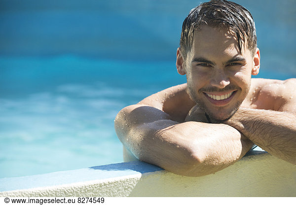 Smiling man relaxing in swimming pool