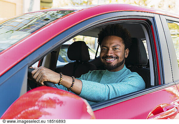 Smiling man sitting in car
